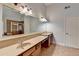 Bathroom showcasing double sinks, granite counters and a tiled shower at 2723 Ivy Bluff Ct, Buford, GA 30519