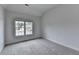 Bright bedroom with a large window offering neighborhood views and plush carpeting at 2723 Ivy Bluff Ct, Buford, GA 30519