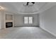 Bedroom features a ceiling fan, fireplace, and large window with natural light at 2723 Ivy Bluff Ct, Buford, GA 30519
