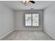 Cozy bedroom features a ceiling fan and window, ideal for a relaxing retreat at 2723 Ivy Bluff Ct, Buford, GA 30519