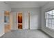 The bedroom has a window, carpet, and doors to the bathroom and closet at 2723 Ivy Bluff Ct, Buford, GA 30519
