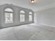 Bonus room with neutral carpet and several large windows providing ample natural light at 2723 Ivy Bluff Ct, Buford, GA 30519