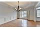 Bright dining area with hardwood floors, wainscoting, and decorative chandelier at 2723 Ivy Bluff Ct, Buford, GA 30519