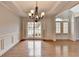 Open dining room area with hardwood floors, chandelier, and arched entryway at 2723 Ivy Bluff Ct, Buford, GA 30519