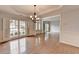 Spacious dining room with hardwood floors, natural light, and stylish chandelier at 2723 Ivy Bluff Ct, Buford, GA 30519