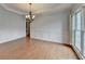Formal dining room featuring hardwood floors, wainscoting, and elegant chandelier at 2723 Ivy Bluff Ct, Buford, GA 30519