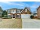 Charming two-story brick home with a well-manicured lawn and two-car garage at 2723 Ivy Bluff Ct, Buford, GA 30519