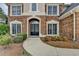 Close-up of the home's front door, featuring brick facade and manicured landscaping at 2723 Ivy Bluff Ct, Buford, GA 30519