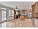 Spacious kitchen with stainless appliances, island and hardwood floors at 2723 Ivy Bluff Ct, Buford, GA 30519