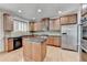 Kitchen featuring stainless appliances, breakfast bar, and hardwood floors at 2723 Ivy Bluff Ct, Buford, GA 30519