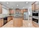 Kitchen featuring stainless appliances, breakfast bar, and hardwood floors at 2723 Ivy Bluff Ct, Buford, GA 30519