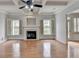 Bright living room featuring a fireplace, hardwood floors, and coffered ceilings at 2723 Ivy Bluff Ct, Buford, GA 30519