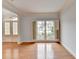 Sun-filled living room boasts hardwood floors, neutral paint, trim accents, and a shuttered window at 2723 Ivy Bluff Ct, Buford, GA 30519