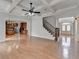 Spacious living room featuring hardwood floors, coffered ceiling, view into the kitchen, and staircase at 2723 Ivy Bluff Ct, Buford, GA 30519