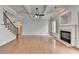 Bright living room with hardwood floors, coffered ceiling, fireplace, and neutral paint color scheme at 2723 Ivy Bluff Ct, Buford, GA 30519