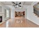 Spacious open living room with hardwood floors, fireplace, coffered ceiling and view into the kitchen at 2723 Ivy Bluff Ct, Buford, GA 30519