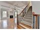Spacious living room with staircase, coffered ceiling, fireplace, hardwood floors, and neutral color palette at 2723 Ivy Bluff Ct, Buford, GA 30519