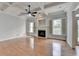 Inviting living room featuring fireplace, hardwood floors, coffered ceiling, and shuttered windows at 2723 Ivy Bluff Ct, Buford, GA 30519