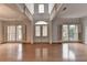 Open living room with hardwood floors, large windows, and high ceilings at 2723 Ivy Bluff Ct, Buford, GA 30519