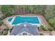 Aerial view of community pool and clubhouse surrounded by trees at 2723 Ivy Bluff Ct, Buford, GA 30519