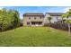 Large backyard with grass, trees and a view of the rear of the two-story home at 461 Summerstone Ln, Lawrenceville, GA 30044