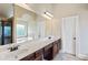 Bathroom vanity with double sinks, granite countertops, and large mirror at 461 Summerstone Ln, Lawrenceville, GA 30044