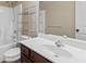 Bright bathroom featuring a shower over tub, shelving and a vanity with a white countertop at 461 Summerstone Ln, Lawrenceville, GA 30044