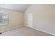 Bedroom featuring neutral walls, carpet and a window overlooking the neighborhood at 461 Summerstone Ln, Lawrenceville, GA 30044