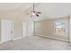 Spacious bedroom with plush carpet, vaulted ceilings, and multiple windows at 461 Summerstone Ln, Lawrenceville, GA 30044