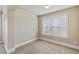 Neutral bedroom features a window, plush carpet, and is painted in neutral colors at 461 Summerstone Ln, Lawrenceville, GA 30044