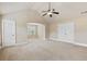 Bedroom with vaulted ceilings, carpeted floors, a ceiling fan, and two closets at 461 Summerstone Ln, Lawrenceville, GA 30044