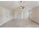 Bedroom featuring carpet floors, two closets, a ceiling fan, and vaulted ceilings at 461 Summerstone Ln, Lawrenceville, GA 30044