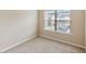 Bedroom featuring neutral colored carpet, walls, and a window overlooking neighborhood at 461 Summerstone Ln, Lawrenceville, GA 30044