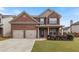 Beautiful two-story brick home featuring a two-car garage and well-maintained lawn at 461 Summerstone Ln, Lawrenceville, GA 30044