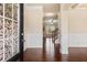 Elegant foyer with hardwood floors, white wainscoting, and a decorative glass front door at 461 Summerstone Ln, Lawrenceville, GA 30044
