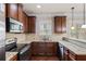 Well-equipped kitchen with stainless steel appliances, granite countertops, and wood cabinets at 461 Summerstone Ln, Lawrenceville, GA 30044