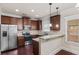Kitchen featuring granite countertops, stainless steel appliances and rich wood cabinetry at 461 Summerstone Ln, Lawrenceville, GA 30044