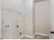 Laundry room with wire rack and tile floor at 461 Summerstone Ln, Lawrenceville, GA 30044