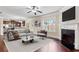Bright living room with a fireplace, ceiling fan, and hardwood floors open to the kitchen at 461 Summerstone Ln, Lawrenceville, GA 30044