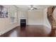 Open-concept living room showcasing hardwood floors, fireplace, and staircase leading to the second floor at 461 Summerstone Ln, Lawrenceville, GA 30044