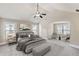 Staged main bedroom with sitting area, and plush carpet at 461 Summerstone Ln, Lawrenceville, GA 30044