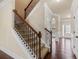 Carpeted staircase with stained wood handrail and decorative wrought iron spindles at 461 Summerstone Ln, Lawrenceville, GA 30044