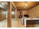 Cozy basement featuring a wood-burning stove, wood-paneled walls, and exposed ceiling at 626 Mincey Ct, Stone Mountain, GA 30087