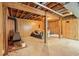 An unfinished basement with concrete floor featuring fireplace and exposed beams at 626 Mincey Ct, Stone Mountain, GA 30087
