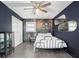 A bedroom with wood-look floors and a dark accent wall featuring a closet and vanity at 626 Mincey Ct, Stone Mountain, GA 30087