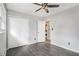 Light filled bedroom featuring wood-look floors, large closet and ceiling fan at 626 Mincey Ct, Stone Mountain, GA 30087