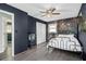 A bedroom with wood-look floors and a dark accent wall featuring a closet and bed at 626 Mincey Ct, Stone Mountain, GA 30087