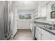 Well-lit kitchen with modern stainless steel appliances and bright white cabinets at 626 Mincey Ct, Stone Mountain, GA 30087