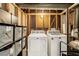 Functional laundry area with a side-by-side washer and dryer setup and shelving at 626 Mincey Ct, Stone Mountain, GA 30087