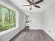 Bright living room with large window and wood-look floors featuring views of the trees at 626 Mincey Ct, Stone Mountain, GA 30087